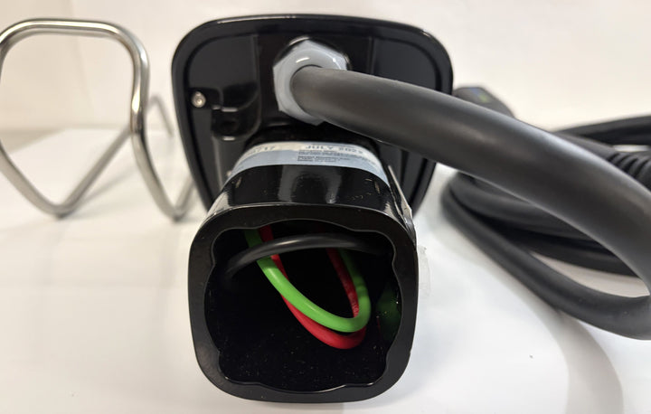 Close-up of a black SemaConnect Level 2 EV charging cable connector showing red and green internal wiring on a clean white surface.