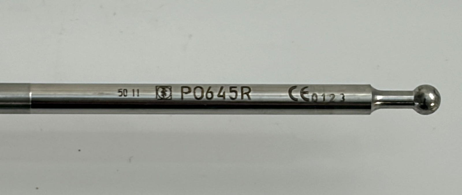 Close-up of a stainless steel laparoscopic grasping forceps insert by Aesculap, featuring a smooth wave-jaw design with product markings on the polished surface.
