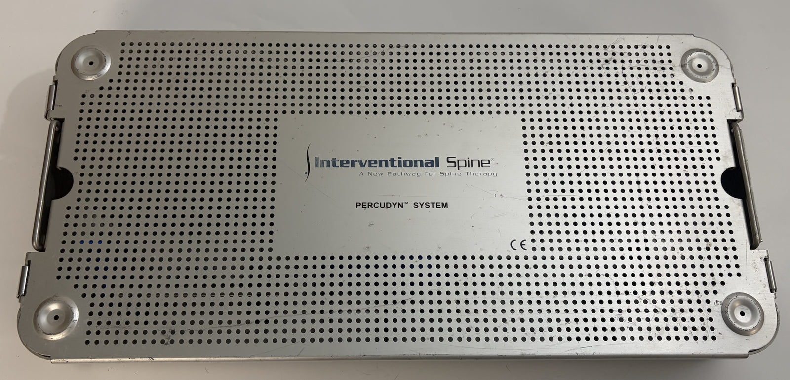 Sterilization tray for surgical instruments featuring perforated metal construction and labeled with the Interventional Spine Percudyn system logo.