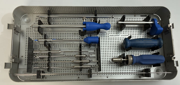 Sterilization tray containing stainless steel surgical instruments with blue handles from Interventional Spine, designed for spine procedures and medical use.
