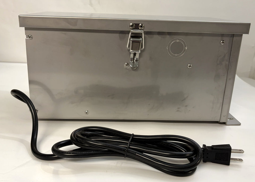 Stainless steel Dauer landscape transformer with secure latch, rectangular housing, and attached black power cord designed for outdoor electrical use.