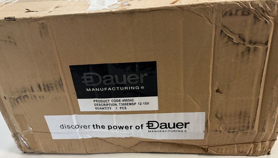 Worn cardboard shipping box labeled with Dauer branding and product details for a 12-15V stainless steel landscape transformer, showing signs of handling and wear.