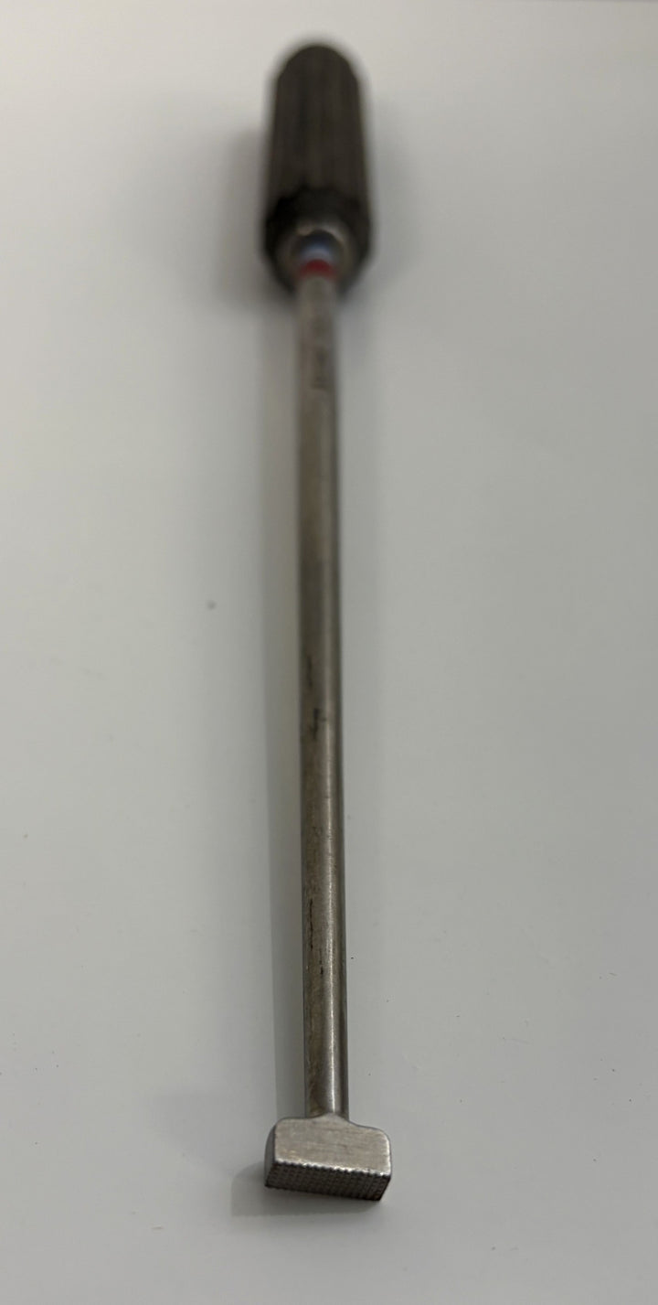 AcroMed bone graft impactor featuring a textured metal tip and grooved black handle, designed for precision use in spinal surgical procedures.