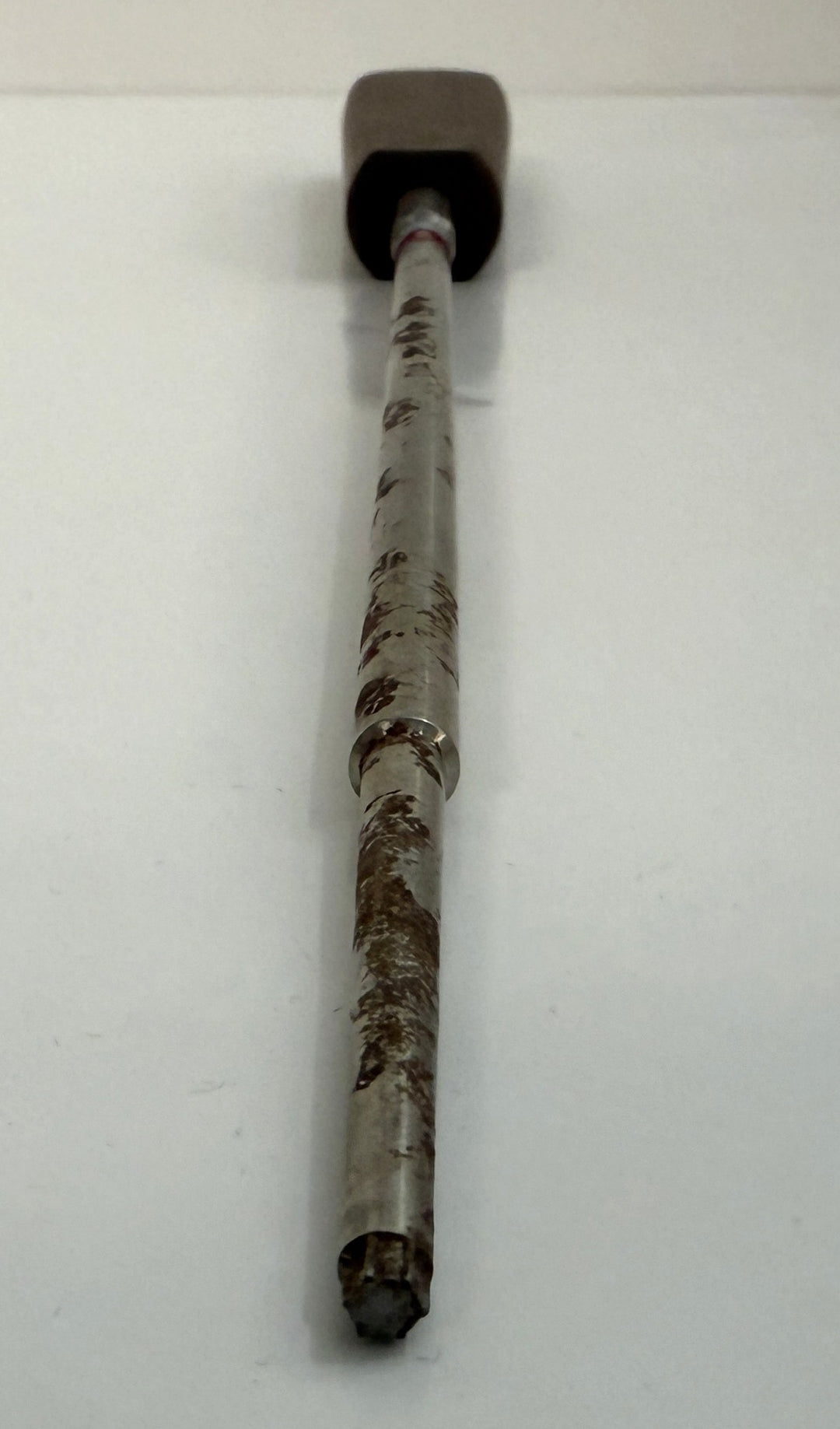 Long metal spinal pedicle probe instrument with a worn surface and black handle, designed for precise surgical use, supplied by Depuy AcroMed.