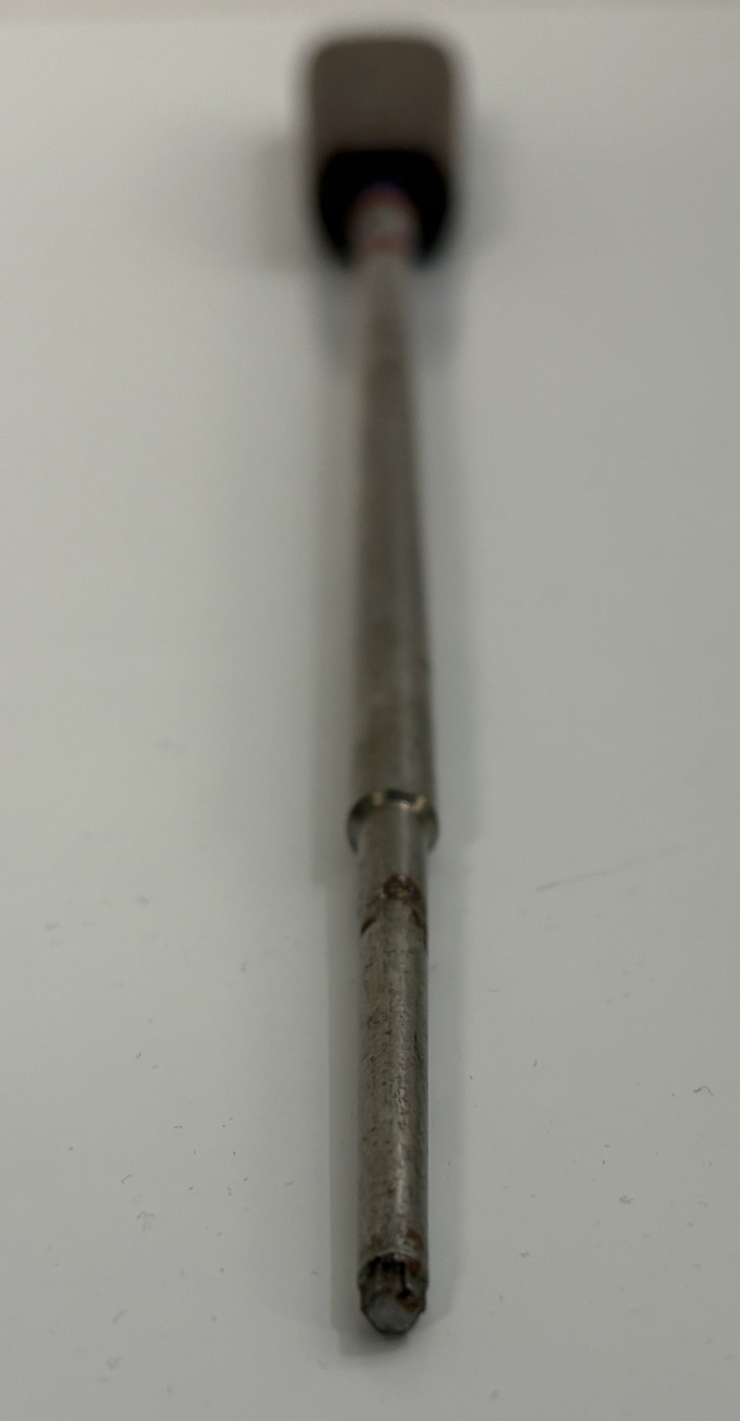 Close-up of a stainless steel spinal pedicle probe from Depuy AcroMed, used in medical procedures, featuring a slender, cylindrical metal shaft with a slightly worn tip.