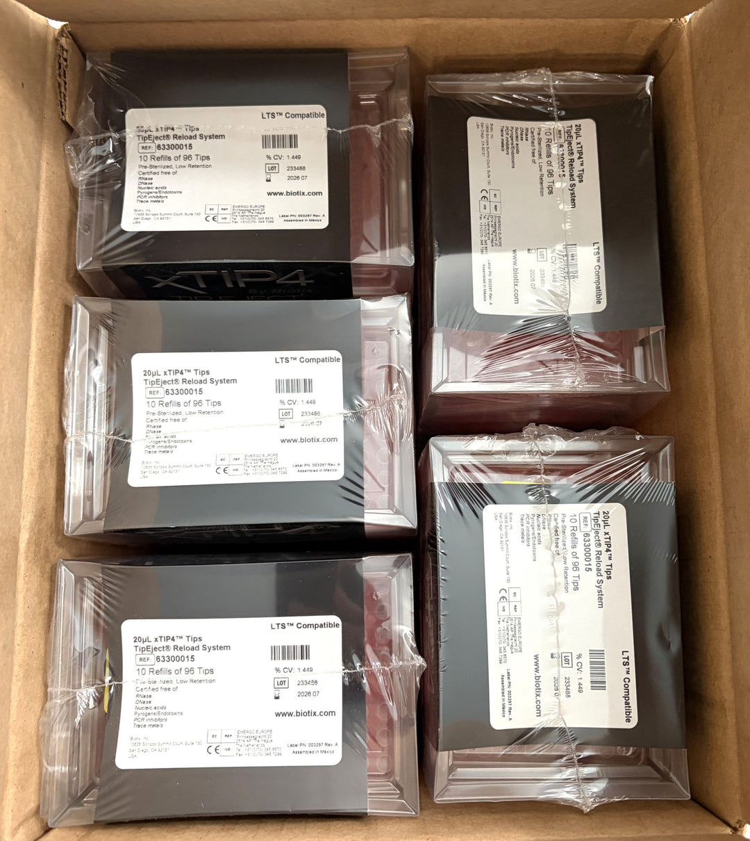 Box containing multiple shrink-wrapped black and red Biotix pipette tip reload system refills for laboratory use with white product labels visible on top of each package.