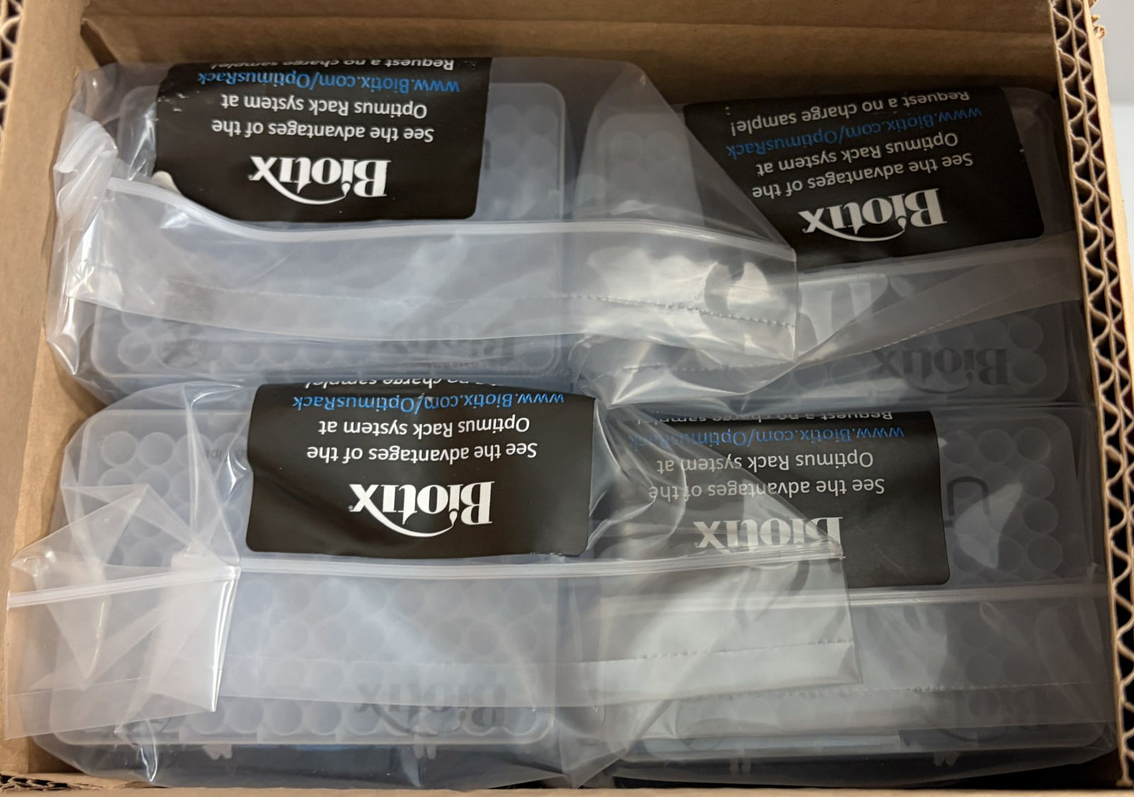 Box containing multiple clear plastic reload cases of Biotix pipette tips individually sealed in transparent packaging, suitable for laboratory use.
