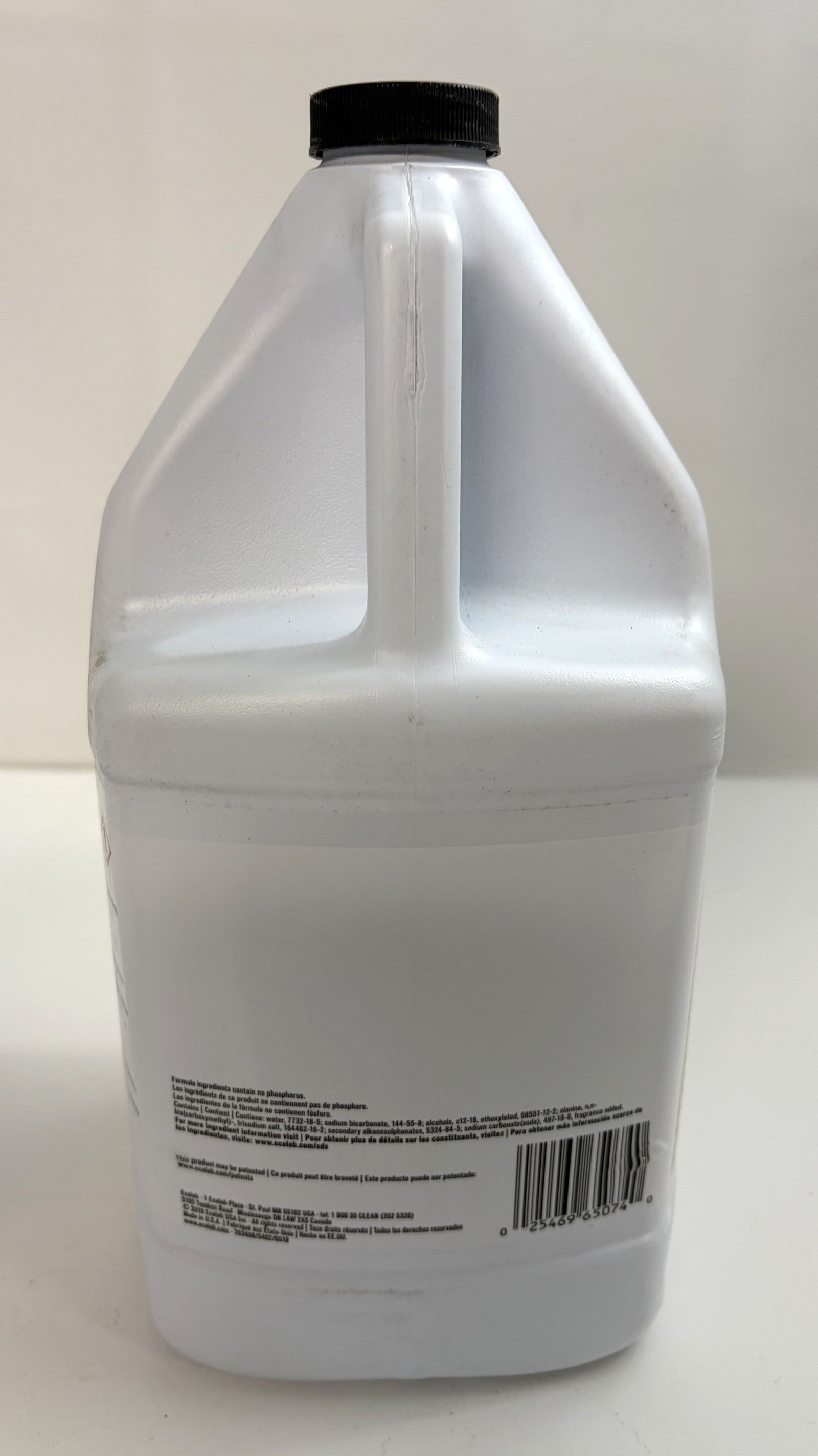 White plastic gallon container with a black screw cap and printed label on the back, containing Ecolab cleaning solution for commercial use.