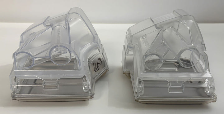 Two clear plastic replacement water chambers designed for Resmed CPAP machines, shown side by side on a plain white surface.