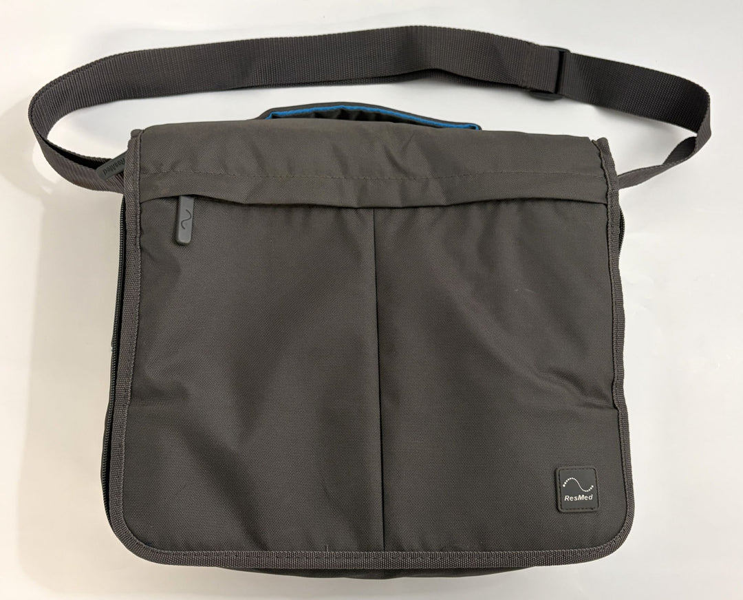 Charcoal gray pre-owned Resmed AirSense 10 CPAP travel bag with adjustable shoulder strap and subtle Resmed logo patch on front flap.