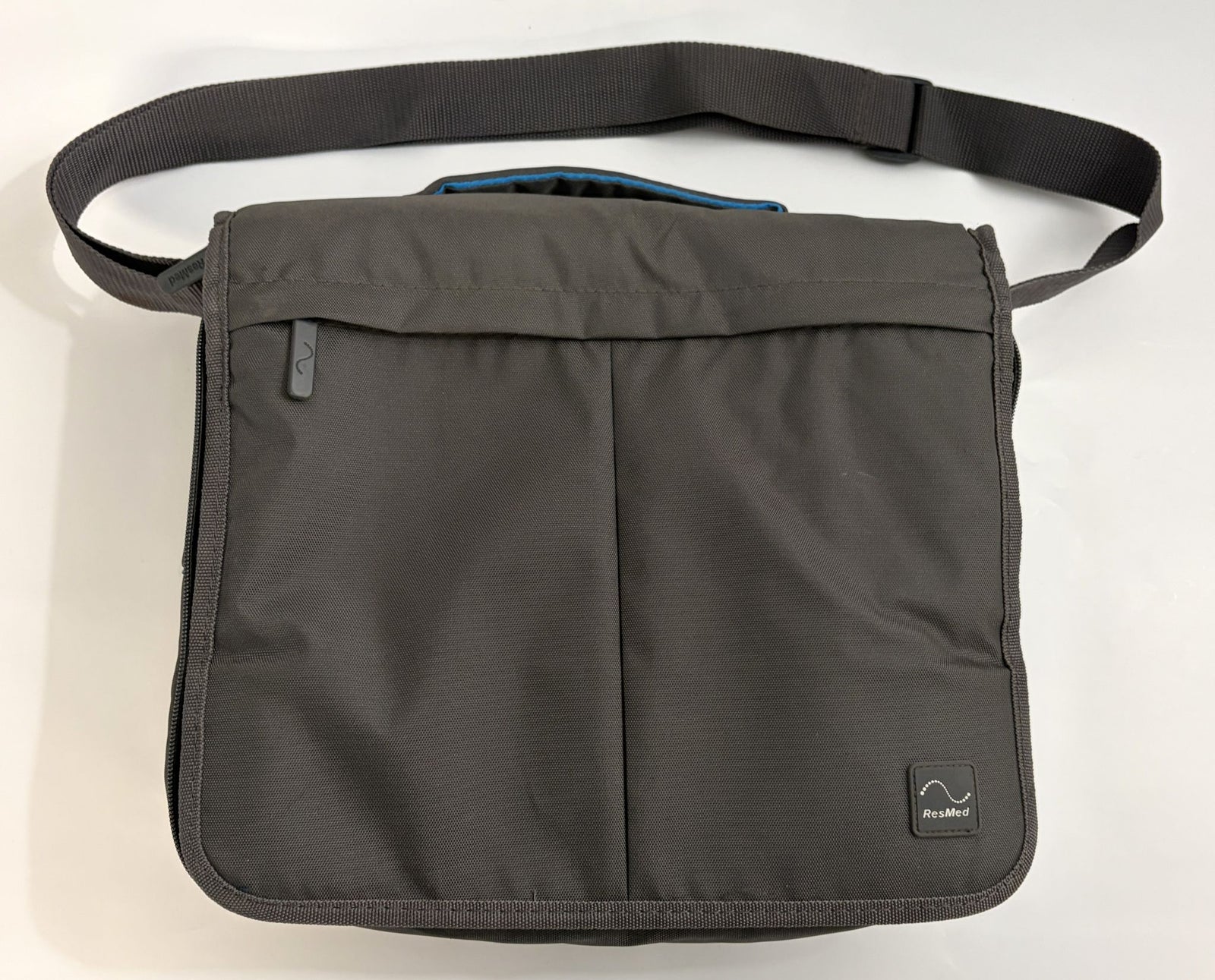 Charcoal gray pre-owned Resmed AirSense 10 CPAP travel bag with adjustable shoulder strap and subtle Resmed logo patch on front flap.