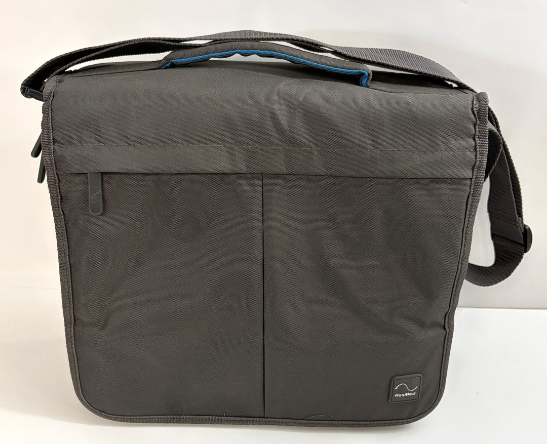 Charcoal gray travel bag designed for Resmed AirSense 10 CPAP device, featuring durable fabric with front zipper pocket and adjustable shoulder strap.