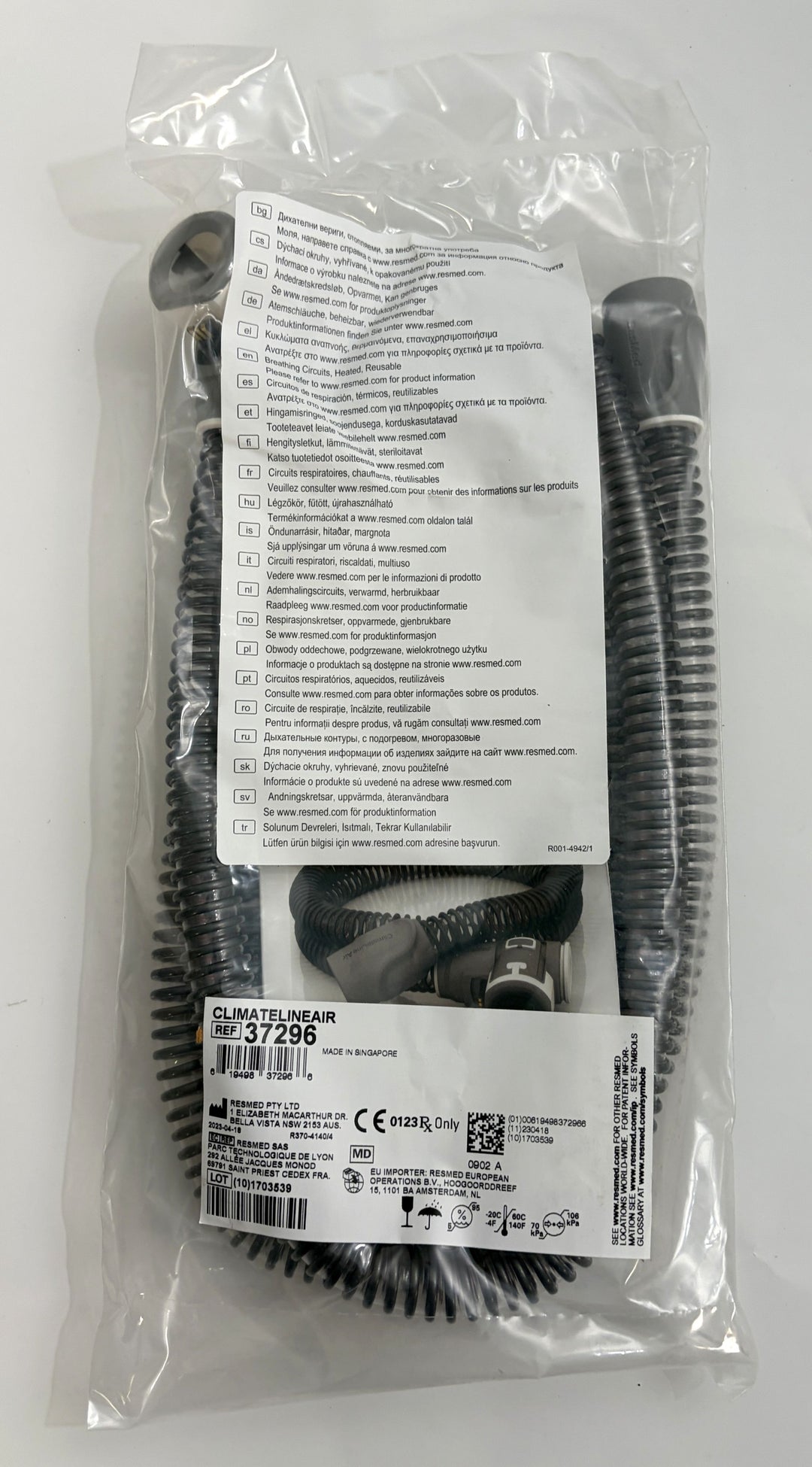 ResMed ClimateLineAir heated CPAP hose in coiled black tubing, factory sealed in clear plastic packaging with product and safety labels visible.