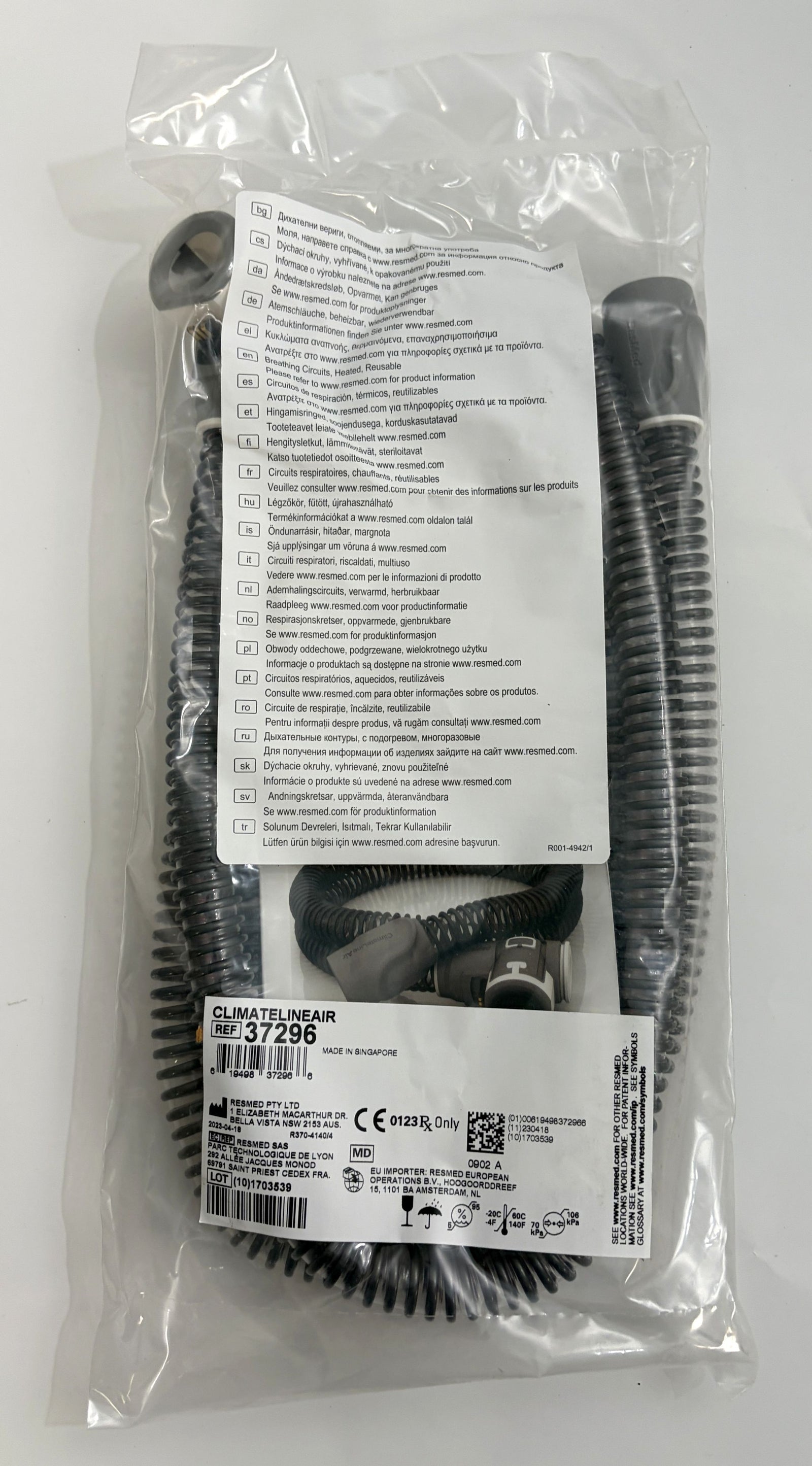 ResMed ClimateLineAir heated CPAP hose in coiled black tubing, factory sealed in clear plastic packaging with product and safety labels visible.