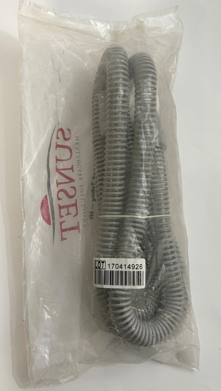 Factory-sealed gray flexible CPAP hose from Sunset Healthcare Solutions, coiled inside clear plastic packaging with visible lot and barcode label.