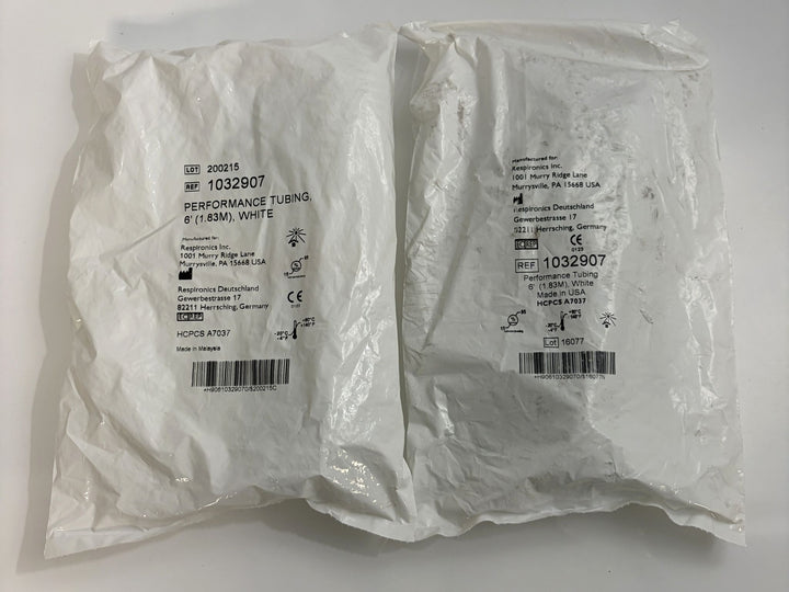 Two white sealed plastic packages containing Respironics performance tubing measuring 6 feet, labeled with product details and barcodes on the outside.