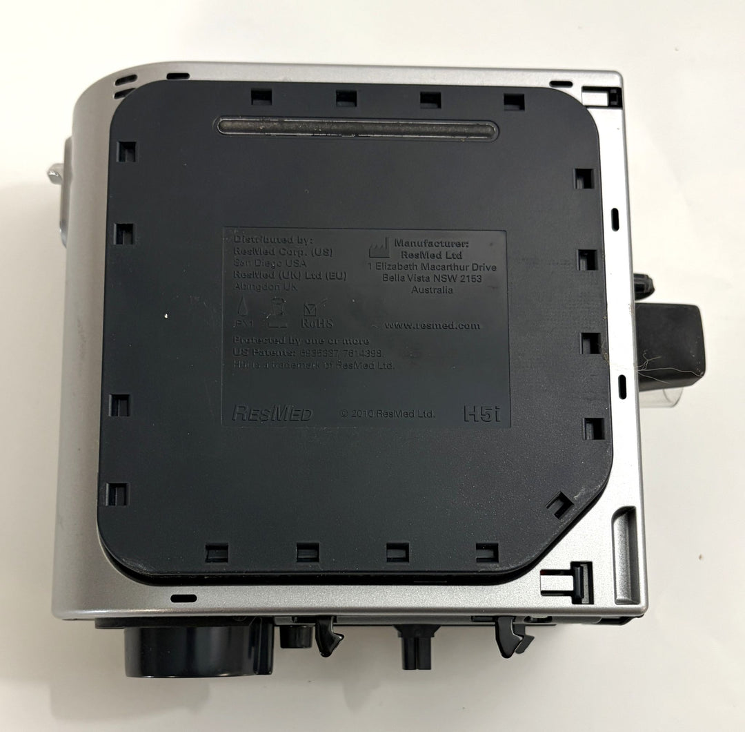 Top view of a pre-owned Resmed H5i humidifier component showing the black plastic cover with embossed manufacturer details and model information.