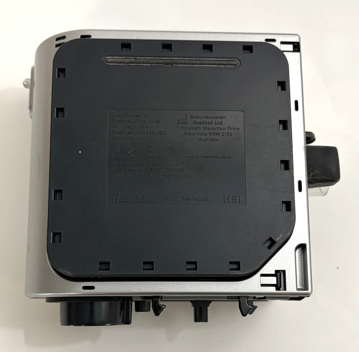 Top view of a pre-owned Resmed H5i humidifier component showing the black plastic cover with embossed manufacturer details and model information.