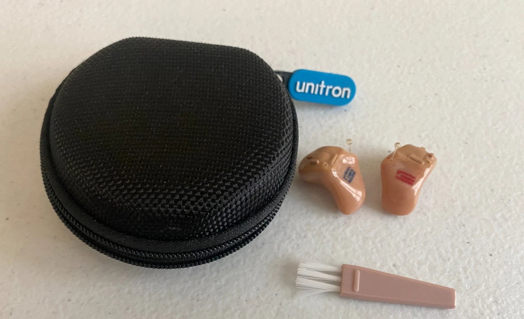 Unitron T Insera left and right hearing aids with black zippered case, cleaning brush, and Unitron tag from PHENTERSALES