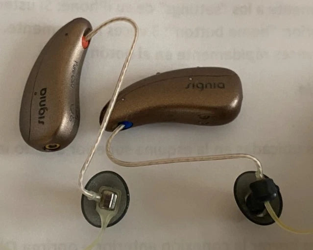 Pair of hearing aids on a light background