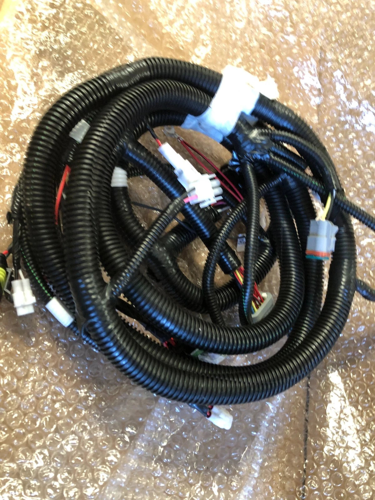 New Yamaha OEM J5A-H2590-10-00 wire harness assembly with black protective conduit and multiple electrical connectors for a golf cart