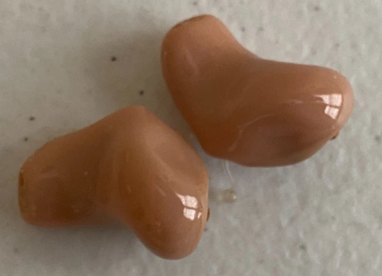 Pair of tan Unitron T Insera hearing aids for left and right ears with glossy in ear shells from PHENTERSALES