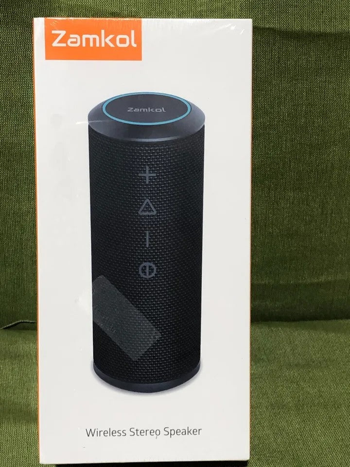 Zamkol wireless portable Bluetooth speaker shown in original sealed packaging with visible front control buttons on black mesh surface for consumer electronics use.