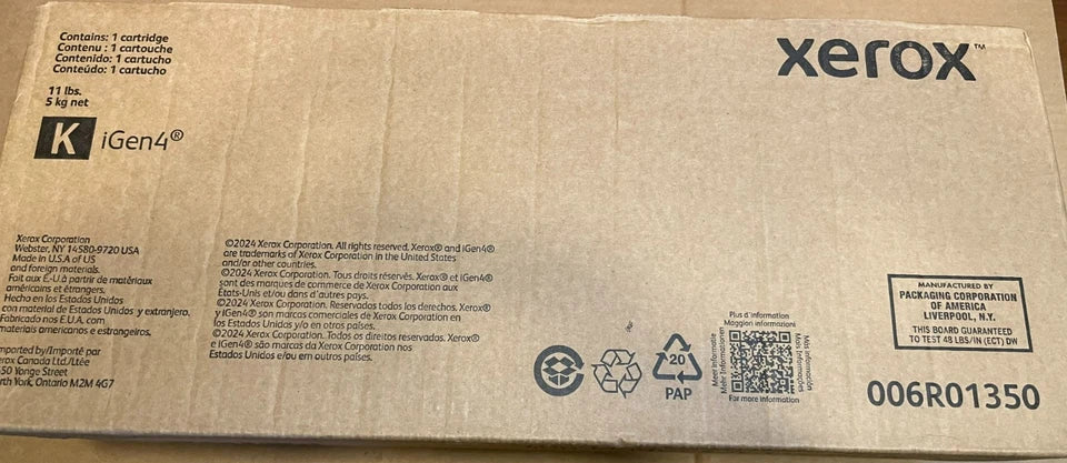 Long rectangular cardboard box for a Xerox black ink toner cartridge with printed text, branding, recycling symbols, and a shipping label from PHENTERSALES.