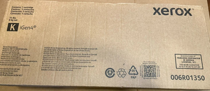 Long rectangular cardboard box for a Xerox black ink toner cartridge with printed text, branding, recycling symbols, and a shipping label from PHENTERSALES.