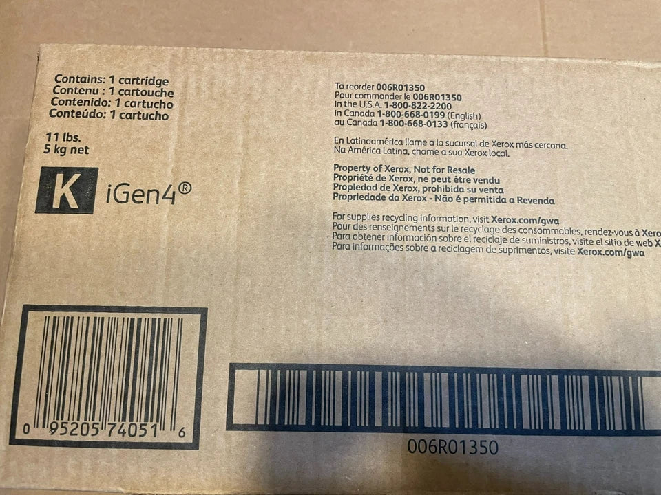 Close-up of sealed cardboard packaging for a black iGen4 toner cartridge by PHENTERSALES with barcodes, weight details, and recycling information printed in multiple languages.