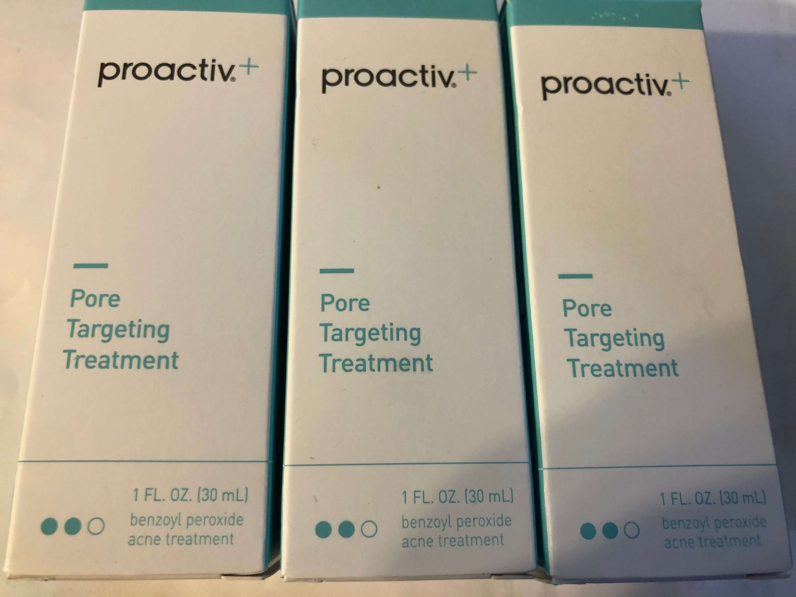 3 bottles of Proactiv+ Pore Targeting Treatment, 1 fl oz each, expiration date: 10/22.